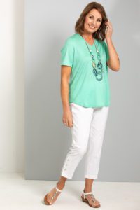Female women model wearing fella hamilton hedrena clothes with a green shirt and white pants