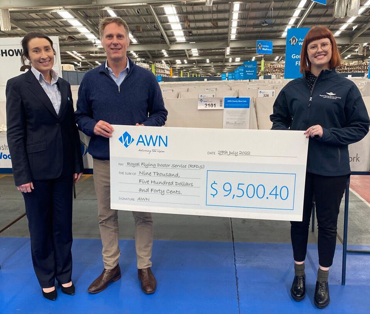 Cassie Baile, Stuart Greensheilds (Endeavour Wool Exports - Wool Buyer) and Sarah Doherty (RFDS Community) are holding up a cheque for Nine Thousand, Five Hundred Dollars and Forty Cents. This cheque is going towards the Royal Flying Doctor Service as a charity donation from AWN.