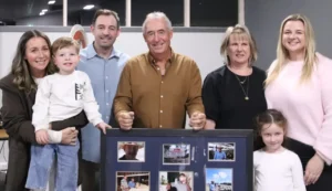 A group portrait of Damien Harrington, his family, and a framed photo collage at his AWN Wimmera Livestock and Property retirement party in Stawell.