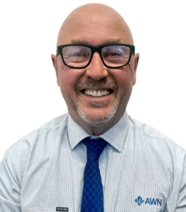 A professional headshot of an AWN wool specialist wearing a blue AWN diamond tie and white striped shirt. 