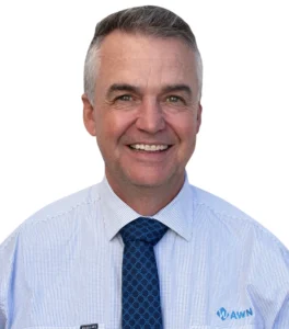 A professional headshot of an AWN wool specialist wearing a blue AWN diamond tie and white striped shirt. 