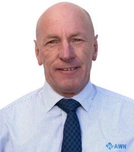 A professional headshot of an AWN wool specialist wearing a blue AWN diamond tie and white striped shirt. 