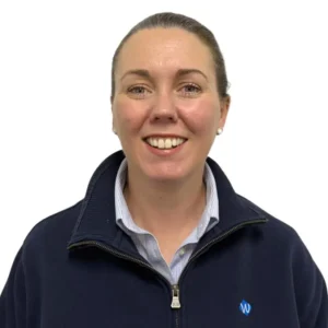 A professional headshot of Lauren Smith, an AWN Business Operations Manager, smiling in a black jacket and white shirt.