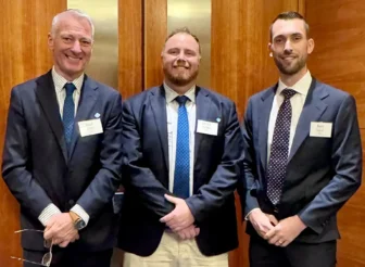 Three people, Rod Miller, Jared Phillips, and Ben Stace, standing from left to right.